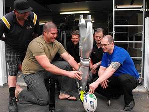 Massey engineering workshop technician Paul Thornton, Massey engineering student Maurice Tipene, Gustav Eiselen from Siemens, Massey workshop manager Eddie Rodgers and Associate Professor Johan Potgieter with the goal-kicking robotic leg.