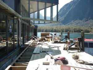  Workmen for Southern Discoveries re-attach the floating pontoon at the Milford Discovery Centre in Milford Sound