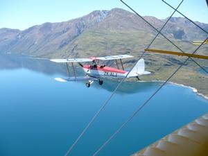 Tiger Moth flies over Lake Wanaka.