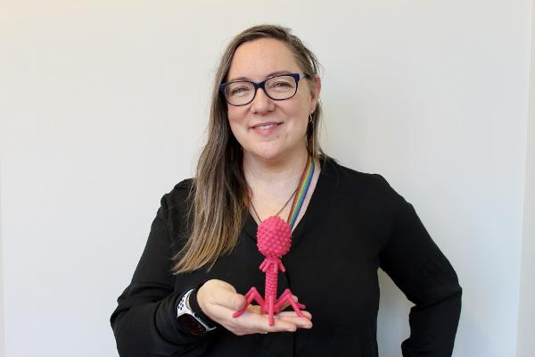 Associate Professor Heather Hendrickson is holding a 3D-printed model of a bacteriophage - highly specific viruses used to target harmful bacteria.