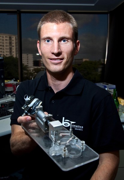 Research student, Casey Jowers holding a cell imaging device
