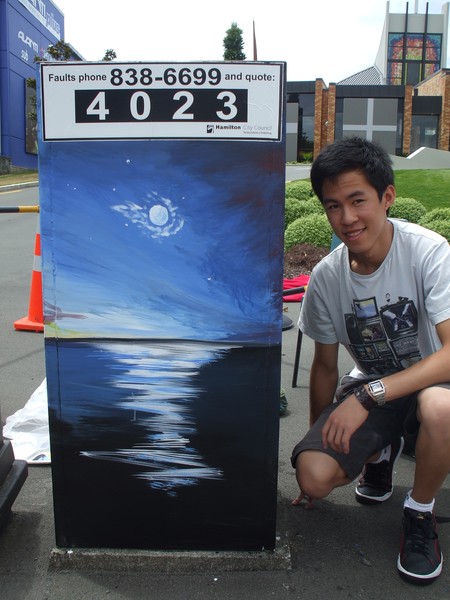 Shang-Poh Yu beside his finished mural 'Moonlit Nights' on the corner of Grey and Bridge Streets