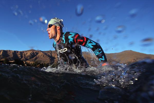 Kieran Doe of New Zealand exits the water after completing the swim leg during Challenge Wanaka on January 21, 2012 in Wanaka, New Zealand.