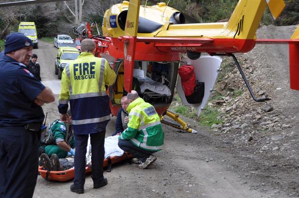 Emergency Services assess and treat injured man before being loaded into Westpac Rescue Helicopter