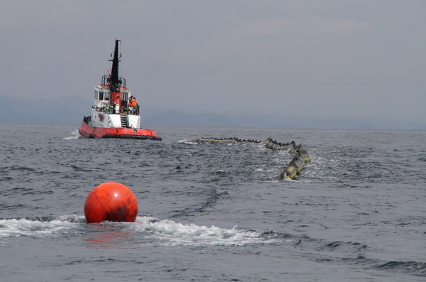 On water oil recovery vessels using booms to contain oil after an oil sheen was observed in the morning.