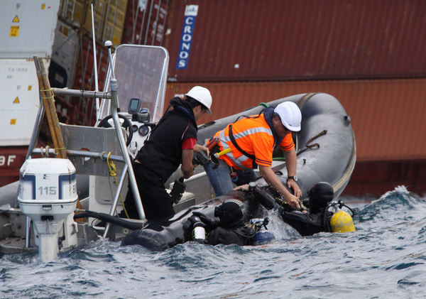 Salvage divers resurface after inspecting the buckling on the Starboard side of Rena.