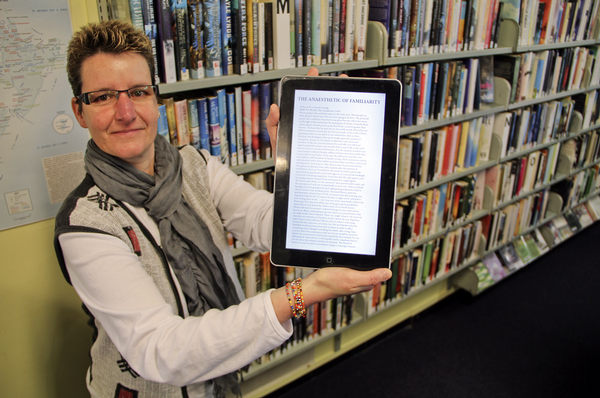  Systems librarian Sabine Beard displays an electronic book she downloaded onto a tablet computer.