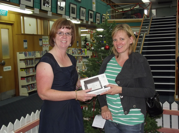 Adele Simmonds accepts her new Kobo eReader from Hastings District Libraries Manager Paula Murdoch.