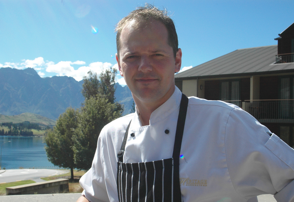 Executive Chef Adrian Lowrey at the Heritage Queenstown with The Remarkables mountain range in the background.