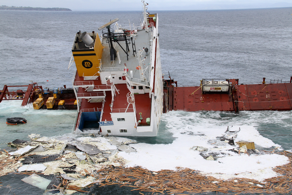 Debris start to emerge from the submerged section of Rena.