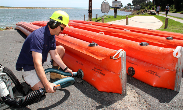 Oil spill responders set up booms at Maket&#363; in anticipation of any fresh oil washing ashore.