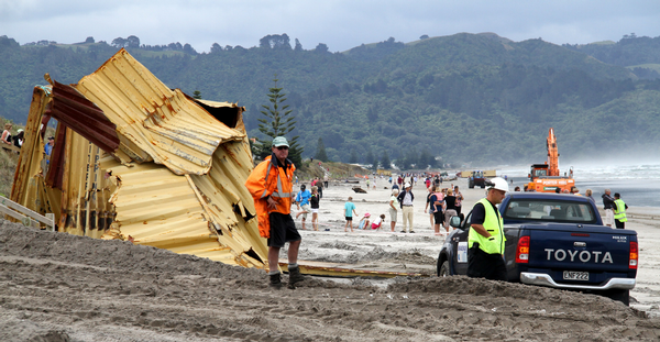 Clean-ups begins again to clear containers and debris off Waihi Beach.