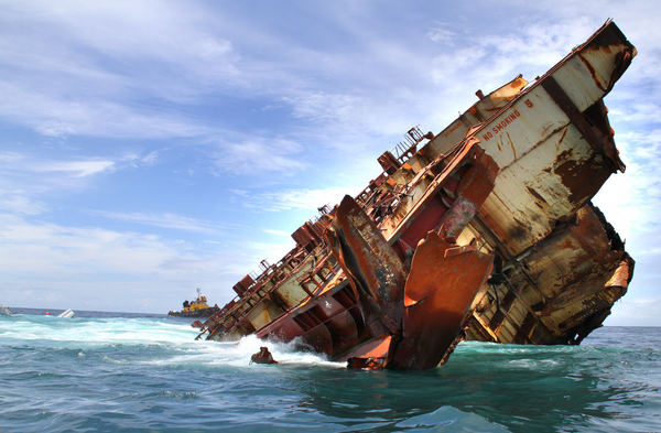 Stern section of the Rena almost totally submerged, with the bridge barely visible at the left. 