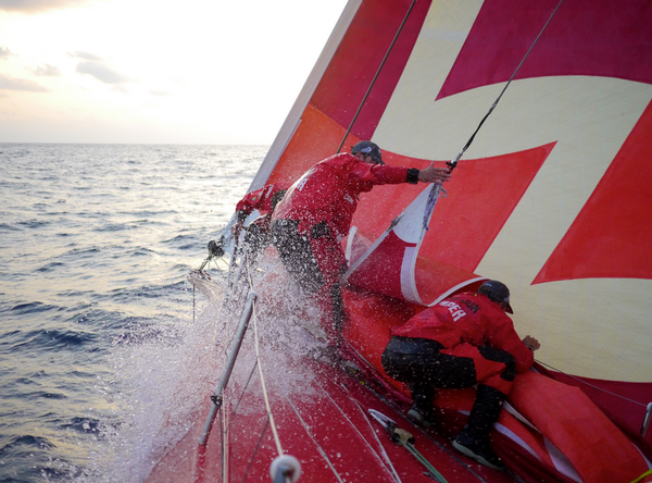 Mike Pammenter, Daryl Wislang and Chris Nicholson make a sail change on the foredeck of CAMPER.