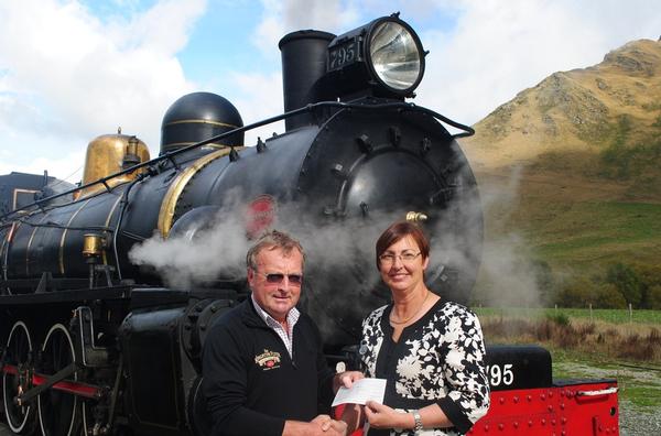 David Bryce owner of The Kingston Flyer hands over $5500 cheque to Judith Hyslop from the Stroke Foundation.