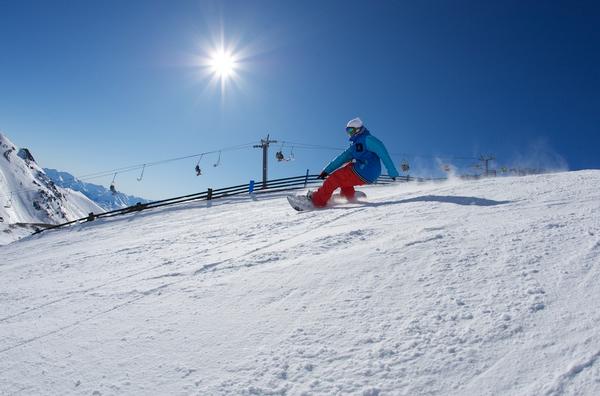 A snowboarder rips it up at The Remarkables ski area.