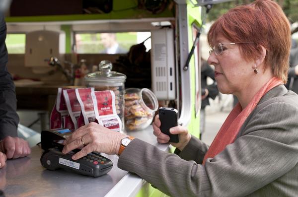 Wellington Mayor, Celia Wade-Brown, buys a coffee using her 2degrees Touch2Pay Smartphone.