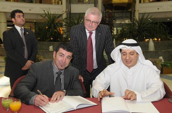 David Reid signing a Middle East deal, witnessed by Trade Minister Tim Groser, before the September 4 earthquake in Christchurch.