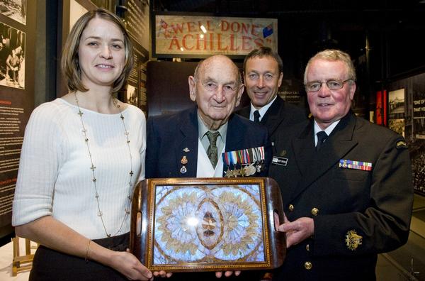 The butterfly tray is presented by Warrant Officer Marty Grogan (Royal Australian Navy) and is presented to the Royal New Zealand Navy Museum Collections Manager Claire Freeman, Navy Veteran Mr Vince McGlone and Commander David Turner, RNZN.