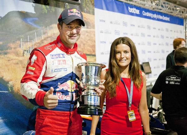 Sebastien Loeb holds Brother Cup next to Emma Crossett from Brother NZ.