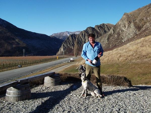 Jeremy Railton with 'Chief' the dog at Mt Rosa Winery with Nevis Bluff in the background.