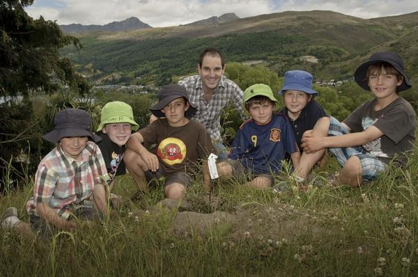 School teacher Grant Hammond and a group of students from Remarkables Primary School planting trees donated by Paper4trees.