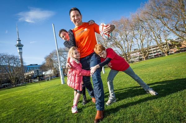 Jetstar Flying Start Programme judge Steve Price is tackled by arthritis sufferers Rhiannon Wood (9 years), Jacob Torensen (14 years) and Dylan Hollick (11 years).