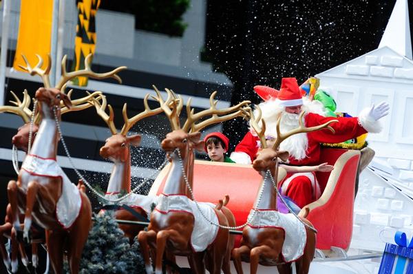 Santa waves to the crowds at the 2011 Farmers Santa Parade.