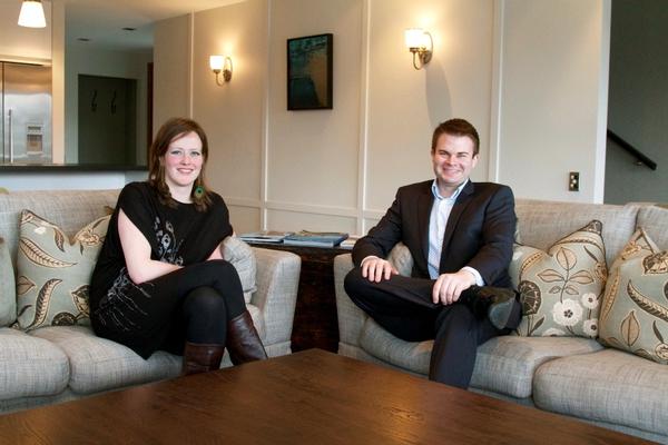 Artist and chef Kathryn Pender and Eichardt's Group General Manager Chris McIntosh relax at The Residence in front of Kathryn's painting 'Milford Deep'.