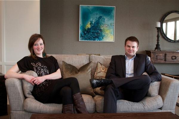 Artist and chef Kathryn Pender and Eichardt's Group General Manager Chris McIntosh relax at The Residence in front of Kathryn's painting 'Humboldt Falls, Fiordland'.