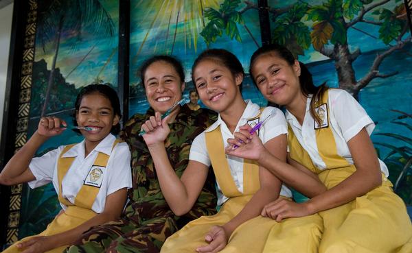 Sergeant Karen Chung, dental hygienist, with Samoan school pupils from Paul VI College.