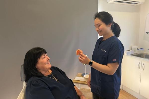 Friendly denture consultation focused on patient comfort and support
