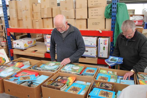 Rotarians Peter Millar and Neil Lewer packing boxes prior to their distribution to local schools.