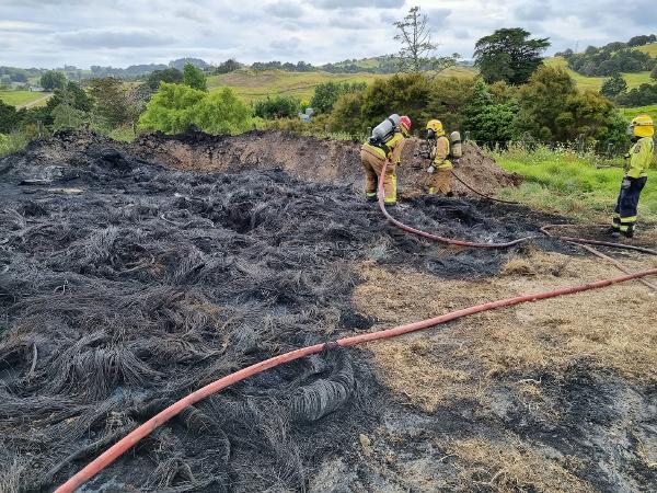 Firefighters at the scene of the tyre burning incident near Kaiwaka last year.