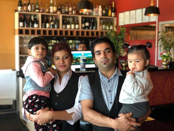 Pictured: Khem Aryal with his wife Ganga Aryal holding their two daughters Krisha and Kristy Aryal.