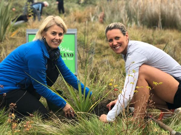 Te Kakano spokeswoman Megan Williams (left) and local Challenge Wanaka competitor Kelly Good plant a tree together in Penrith Reserve near Beacon Point to celebrate Challenge Wanaka and Te Kakano becoming official partners. 
