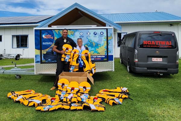 Safety Ambassador Dane Karapu and local kuia Ellen Hardiman of Whangaruru's Tuparehuia Marae Committee with the lifejackets the marae will hold for use by local and visiting boaties.
