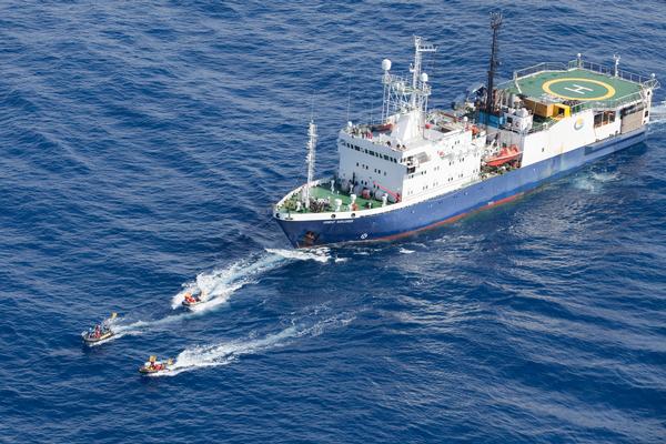 Inflatables with activists in front of the oil survey ship Orient Explorer