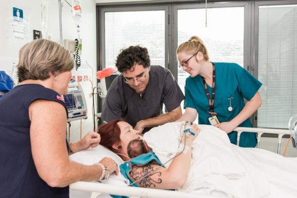 Midwives at work alongside a new mum