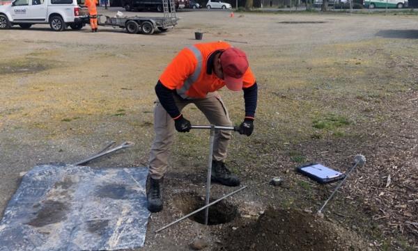 Ben Chaw from engineering environmental project management company Tetra Tech Coffey working with a hand drill as geotechinical testing gets underway on the development project at Prebbleton Village Square. 
