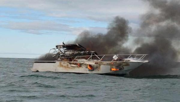 Photo of the 13-metre aluminium boat on fire taken from the Waikato Regional Council harbourmaster vessel. Credit: Waikato Regional Council