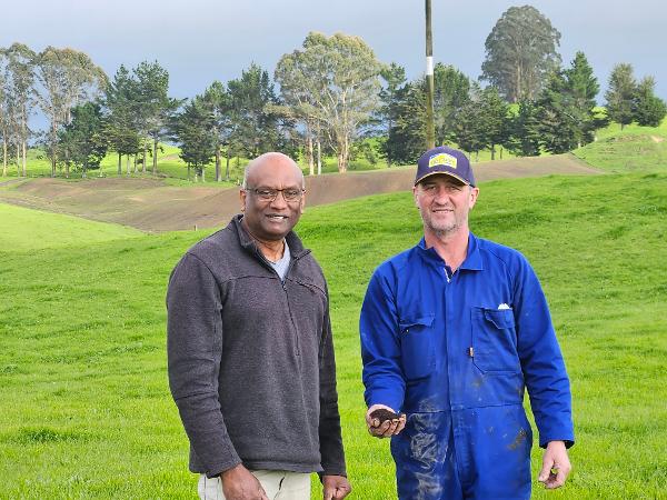 Dr Gordon Rajendram and Mark Robertson (holding Humates) on a pumice soil farm in Taupo
