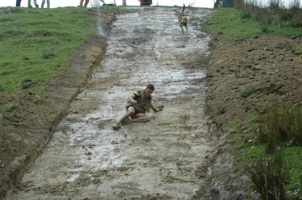 Eukanuba Shepherds' Shemozzle 2016 Winner Nugget the Huntaway with fellow contestant Nick Tipling, hurtling down the Mud Slide challenge