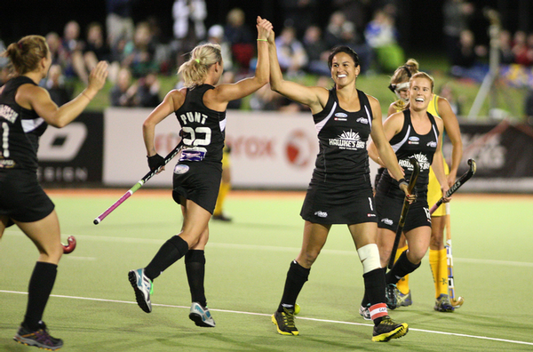 Black Sticks Anita Punt (left) high fives co-captain Kayla Sharland during their 2012 Four Nations final against Australia at North Harbour Hockey Stadium. 