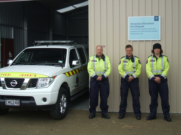 Graham McLean, Terry Welsh and Daniel Leopold (of the Omarama Volunteer Fire Brigade) in front of the new building.