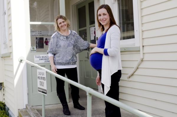 A midwife meets her client at an antenatal appointment