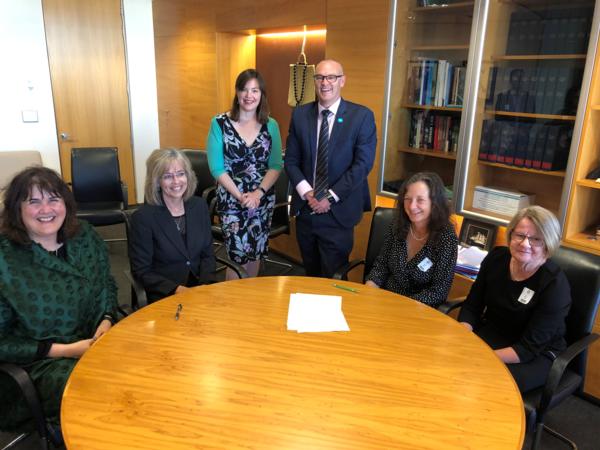 L to R Keriana Brooking (Dep Dir-Gen on behalf of MoH), Helen Mason (CE BoP signing on behalf of DHBs),  Hon Julie Anne Genter (Assoc Min of Health),  Hon David Clark (Min of Health),  Caroline Conroy (MERAS Co-leader: Midwifery) and Hilary Graham-Smith (Associate Professional Services Manager NZNO)