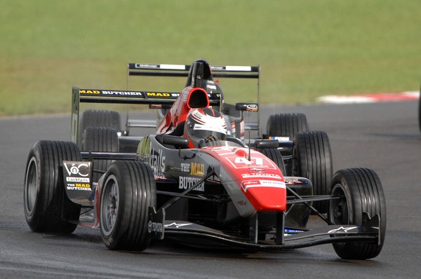 Auckland's Daniel Gaunt has won the New Zealand Grand Prix for a second time in wet changeable conditions at the Manfeild race circuit for Triple X Motorsport.