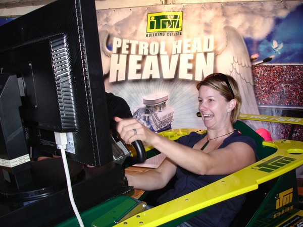 A race fan enjoys a simulated V8 Supercar race while at the Hamilton 400