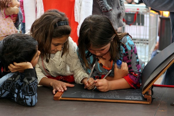 Children sign the Condolence Book for the Pike River miners and their families